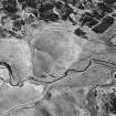 Girron, oblique aerial view, taken from the N, centred on cultivation terraces and small cairns.