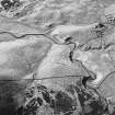 Girron, oblique aerial view, taken from the SE, centred on cultivation terraces and small cairns.