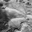 Girron, oblique aerial view, taken from the E, centred on cultivation terraces and small cairns.