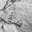 Glen Fender, oblique aerial view, taken from the N, centred on the remains of a township. Footings of a farmstead and buildings are visible in the centre right of the photograph.