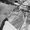 Logierait, oblique aerial view taken from the NE, centred on the cropmarks of a souterrain, roundhouses, pits and a fort.