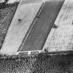 Oblique aerial view centred on the cropmarks of the watch tower, taken from the SSE.