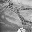 Leadketty, oblique aerial view, taken from the WNW, centred on the cropmark of an enclosure. An alignment of pits in the centre left of the photograph is part of a large pit-defined enclosure.