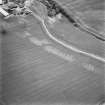 Leadketty, oblique aerial view, taken from the WNW, centred on the cropmarks of an enclosure, a possible enclosure, pits and rig.