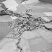 Oblique aerial view of Dunning centred on the cropmarks of a Roman temporary camp and the village, taken from the NNW.
