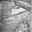 Inverdunning House and Wellhill, oblique aerial view, taken from the NE, centred on the cropmarks of enclosures, a ring-ditch, pit-circles, rig, cropmarks and pits. Inverdunning House and walled garden are visible in the bottom right-hand corner of the photograph and Wellhill farmsteading is shown in the top centre.