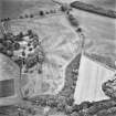 Inverdunning House and Wellhill, oblique aerial view, taken from the WNW, centred on the cropmarks of enclosures, ring-ditches, pit-circles, rig, cropmarks and pits. Inverdunning House and walled garden are visible in the centre left half of the photograph.