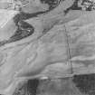 Oblique aerial view centred on the cropmarks of enclosures, henges, ring-ditches, a pit-enclosure and barrows, taken from the SE.