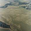 Oblique aerial view centred on the cropmarks of enclosures, henges, ring-ditches, a pit-enclosure and barrows, taken from the E.