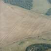 Oblique aerial view in hazy conditions centred on the cropmarks of the enclosure, with the cropmarks of the henges, possible henge, pit-enclosure, enclosure, ring-ditches and other cropmarks adjacent, taken from the W.
