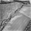 Kincladie, oblique aerial view, taken from the SSE, centred on an area of cropmarks, including those of a pit-circle, pits and field boundaries.