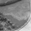 Green of Invermay, oblique aerial view, taken from the NW, centred on the cropmark of a ring-ditch and parts of a possible pit-alignment. Invermay House dovecot is visible in the centre left of the photograph, and further pits can be seen in the centre right.