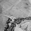 Oblique aerial view centred on the house, gate-lodge and cottage with the cropmarks of rig adjacent, taken from the E.