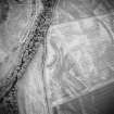 Oblique aerial view centred on the geological cropmarks with rig adjacent, taken from the NNW.