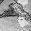 Oblique aerial view of Dun Knock centred on the cropmarks of the fort and plantation bank, taken from the NNW.