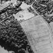 Oblique aerial view of Dun Knock, Dunning centred on the cropmarks of a fort with school adjacent, taken from the NE.