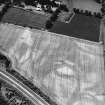 Ruthvenfield House, Huntingtower, oblique aerial view, taken from the NE, showing the cropmarks of the formal garden and parallel linear cropmarks. Ruthvenfield House is visible in the upper left-hand corner of the photograph.