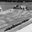 Oblique aerial view centred on linear cropmarks, taken from the NW.