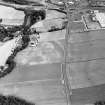 Oblique aerial view of Huntingtower and Huntingtower Mains centred on the cropmarks of a Roman road, enclosure, pit-circle, pits and various linear cropmarks and miscellaneous cropmarks, taken from the WNW.