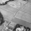Oblique aerial view of Huntingtower and Huntingtower Mains centred on the cropmarks of a Roman road, enclosure, pit-circle, pits and various linear cropmarks and miscellaneous cropmarks, taken from the SW.