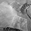 Oblique aerial view centred on the cropmarks of the possible henge, cropmarks and rig, taken from the SW.