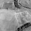 Oblique aerial view centred on the cropmarks of the possible henge, cropmarks and rig, taken from the WSW.