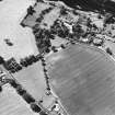 Oblique aerial view centred on the cropmarks of the unenclosed settlement with church and smithy adjacent, taken from the E.