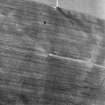 Oblique aerial view centred on the faint cropmarks of an enclosure, taken from the ENE.