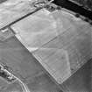 Oblique aerial view of Victoria Cottage centred on linear cropmarks with farmhouse, farmsteading and road bridge adjacent, taken from the NW.