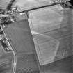 Oblique aerial view of Victoria Cottage centred on linear cropmarks with farmhouse, farmsteading and road bridge adjacent, taken from the WNW.