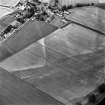 Oblique aerial view of Victoria Cottage centred on linear cropmarks with village adjacent, taken from the SW.