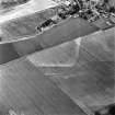 Oblique aerial view of Victoria Cottage centred on linear cropmarks with village adjacent, taken from the SSW.