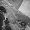 Orwell, oblique aerial view, taken from the SE, centred on the cropmarks of a rectilinear enclosure and a possible enclosure. Orwell Old Parish Church and Manse are visible in the bottom right-hand corner of the photograph.