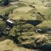 Oblique aerial view centred on the remains of the fermtoun with enclosures and rig adjacent, taken from the NNW.