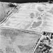 Kercock, oblique aerial view, taken from the SE, centred on an area of cropmarks, including those of an enclosure and a ring-ditch.