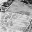 Kercock, oblique aerial view, taken from the NW, centred on an area of cropmarks, including those of an enclosure and a ring-ditch.