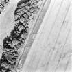 Hallhole, oblique aerial view, taken from the WSW, centred on an area of cropmarks, including a round house and an enclosure.