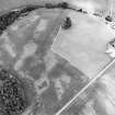 Oblique aerial view centred on the cropmarks of an unenclosed settlement with natural feature adjacent, taken from the SSW.