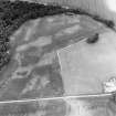 Oblique aerial view centred on the cropmarks of an unenclosed settlement with natural feature adjacent, taken from the SSE.