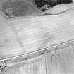 Oblique aerial view centred on the cropmarks of the possible buildings or mortuary enclosures and rig with the pit-alignment adjacent, taken from the NW.