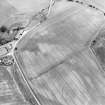 Oblique aerial view centred on the cropmarks of the possible buildings or mortuary enclosures and rig with the pit-alignment adjacent, taken from the WSW.