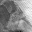 Oblique aerial view centred on the cropmarks of the quarry pits flanking a Roman Road with linear cropmarks and unenclosed settlement adjacent, taken from the WSW.