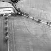 Oblique aerial view centred on the cropmarks of hollow trackways and rig, taken from the NNW.