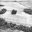 Mugdrum, oblique aerial view, taken from the NNW, centred on an area defined as a cropmark complex and on a possible enclosure.