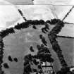 Myres Castle, oblique aerial view, taken from the E, centred on the cropmarks of a fort. Myres Castle Walled Garden is visible in the bottom centre of the photograph.