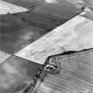 Oblique aerial photograph of Reedieleys centred on cropmarks, including cultivation remains and rig, taken from the SW.