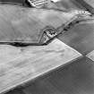 Oblique aerial photograph of Reedieleys centred on cropmarks, including cultivation remains and rig, taken from the NE.