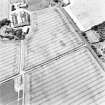 Mains of Errol, oblique aerial view, taken from the E, centred on the cropmarks of a round-house and possible round-house.
