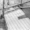 Oblique aerial view centred on the cropmarks of the souterrains, pits and rig, taken from the NW.