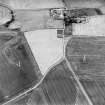 Oblique aerial view of Hallyards centred on the cropmarks of a moated site, taken from the SSE.